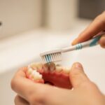 Dentist examining patient's gums in a modern dental office
