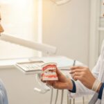 Dentist explaining dental deep cleaning to a patient in a professional setting